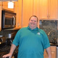 man smiling in kitchen